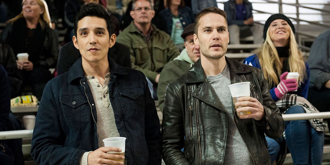 Gabriel Luna and Taylor Kitsch drinking beer on bleachers in True Detective season 2