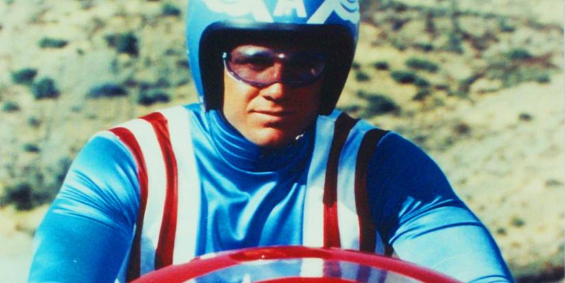 Reb Brown in Captain America (1979) rising a motorcycle with his shield up front