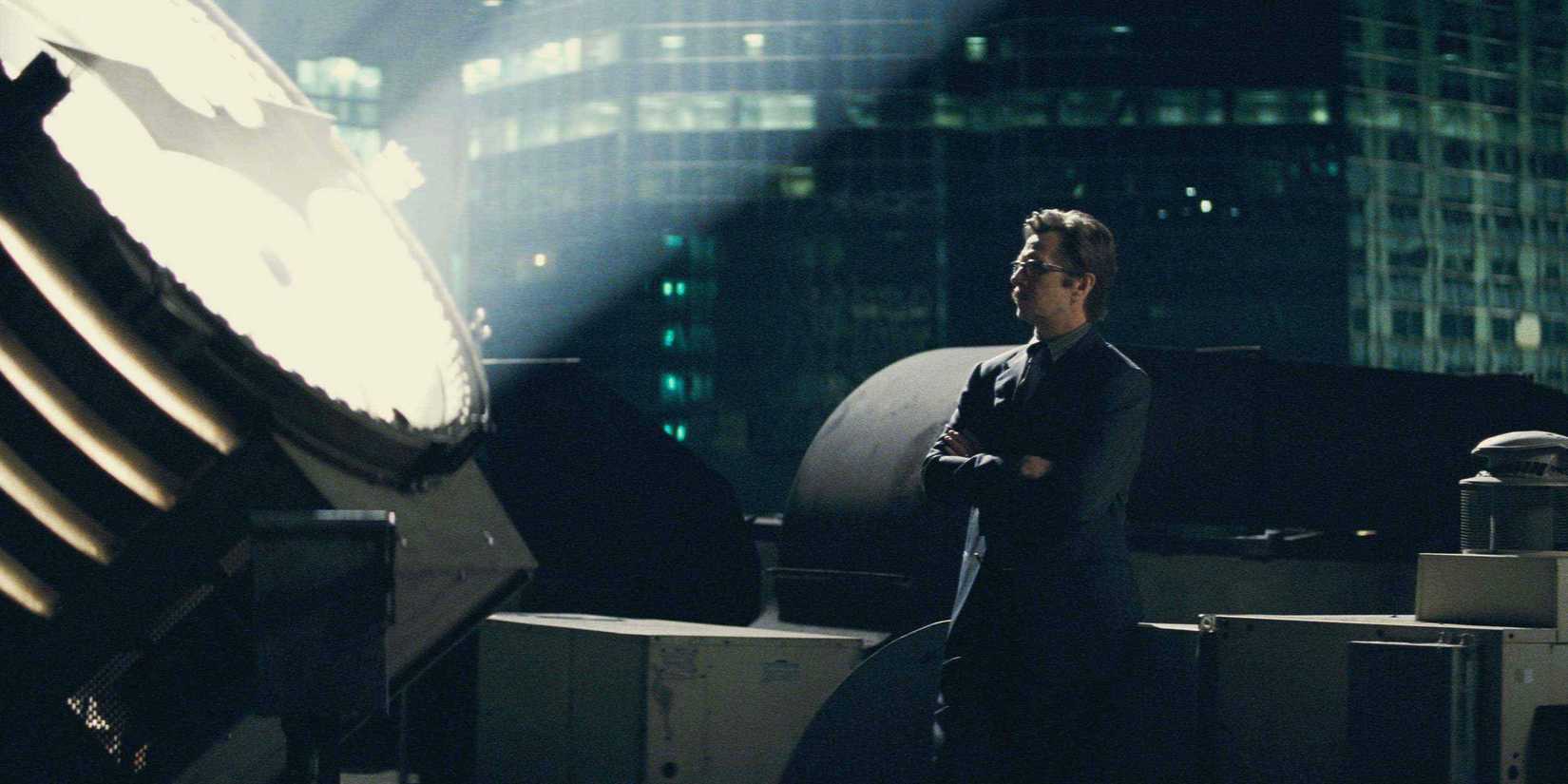 Jim Gordon looking at the Bat signal in Dark Knight ending