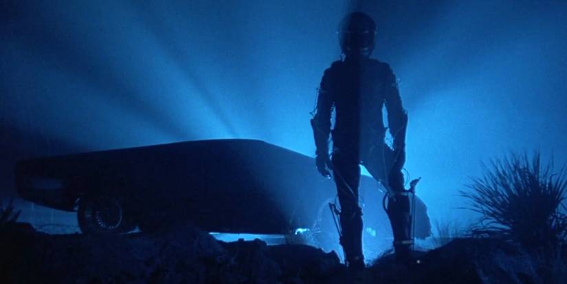 Charlie Sheen as Jake in a blue backlit shot in The Wraith