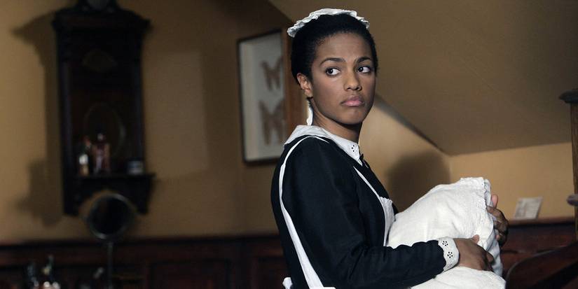 Martha wearing a maid's outfit and looking back in Doctor Who.