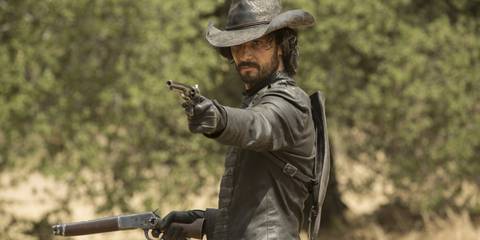 Rodrigo Santoro as Hector, aiming his pistol in Westworld