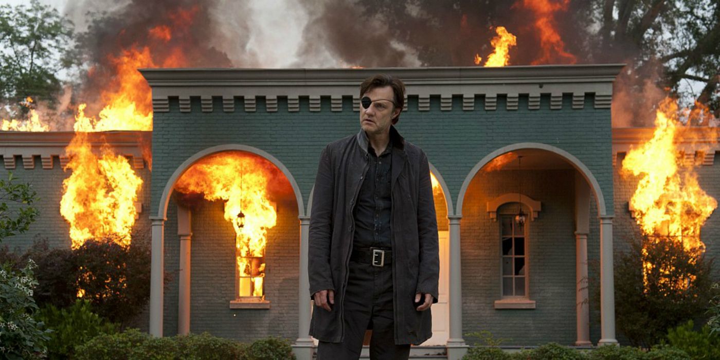 The Governor standing in front of a burning villain in The Walking Dead