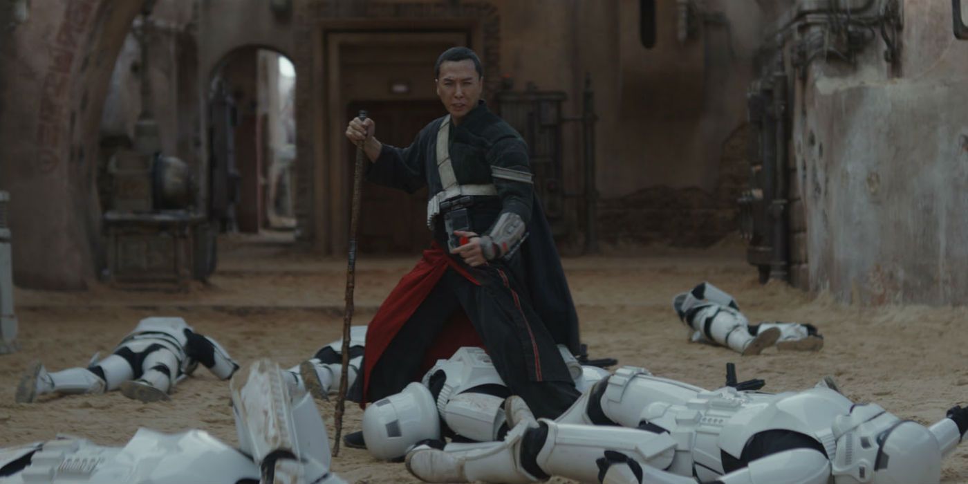 Chirrut Îmwe triumphantly stands the defeated stormtroopers in a deserted town in Rogue One: A Star Wars Story