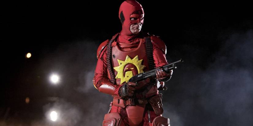 Rainn Wilson as the Crimson Bolt wielding a shotgun in Super