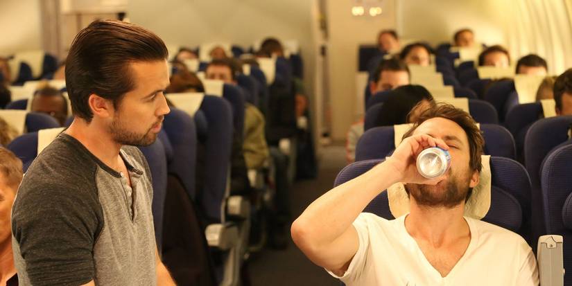 Mac watches as Charlie drinks a beer on a plane in It's Always Sunny in Philadelphia 