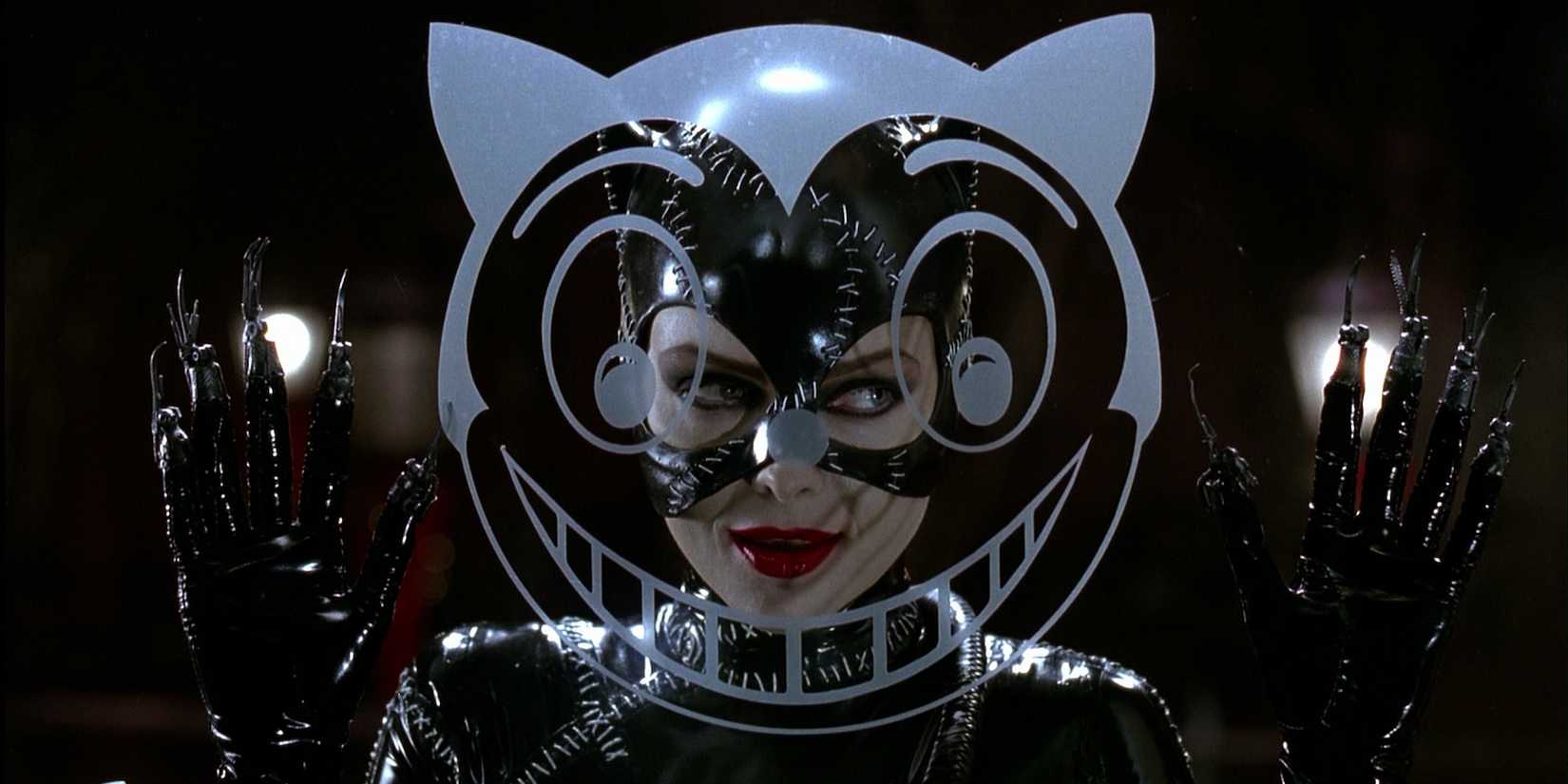 Selina Kyle (Michelle Pfeiffer) in her Catwoman suit looking through a window in Batman Returns