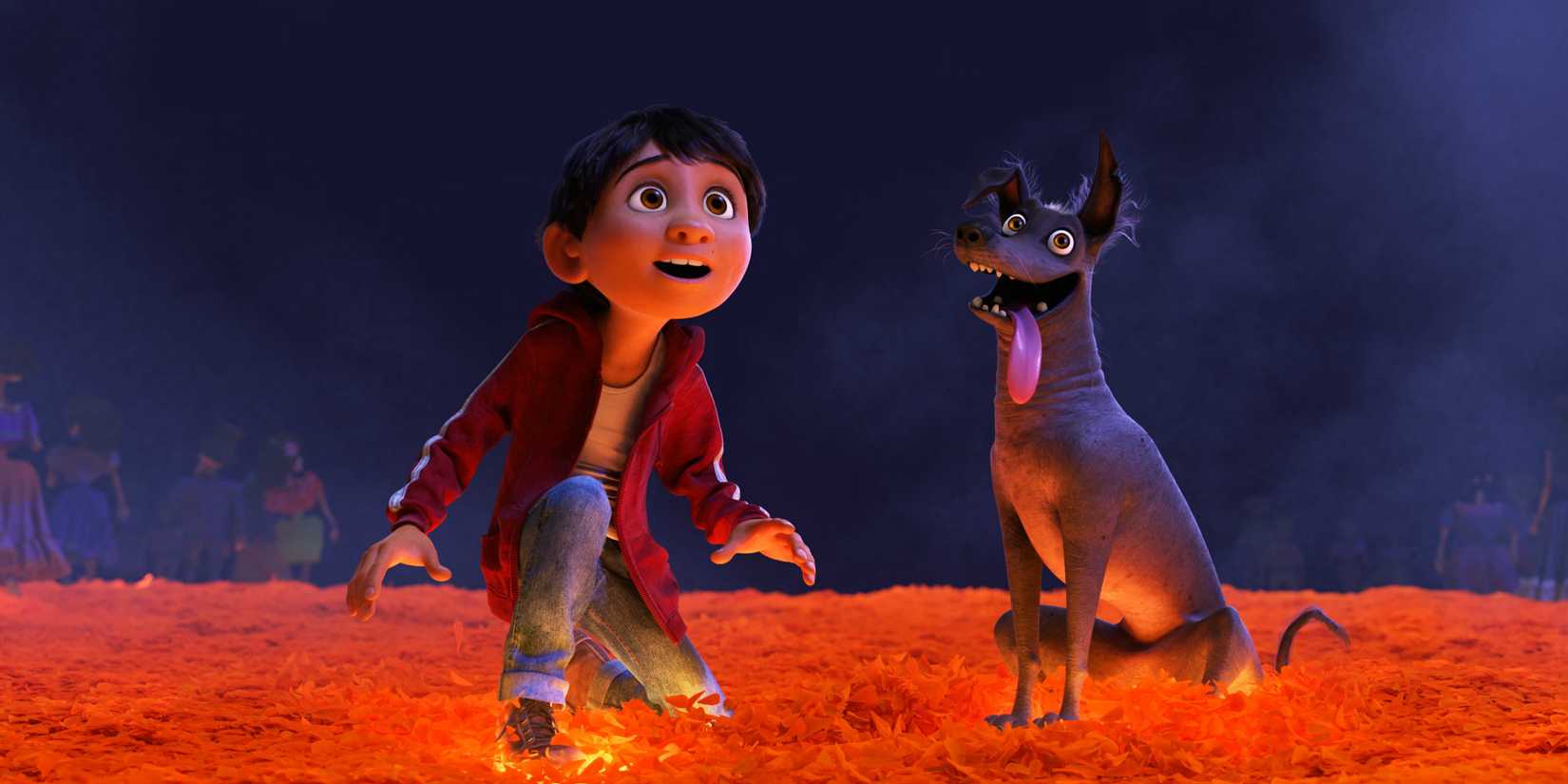 Miguel crouching down near his dog in Coco