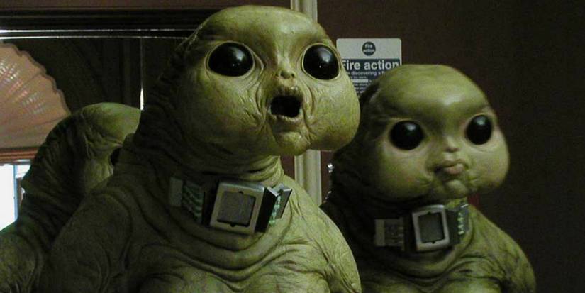 Two Slitheen looking stunned as they stand in Downing Street in Doctor Who season 1.