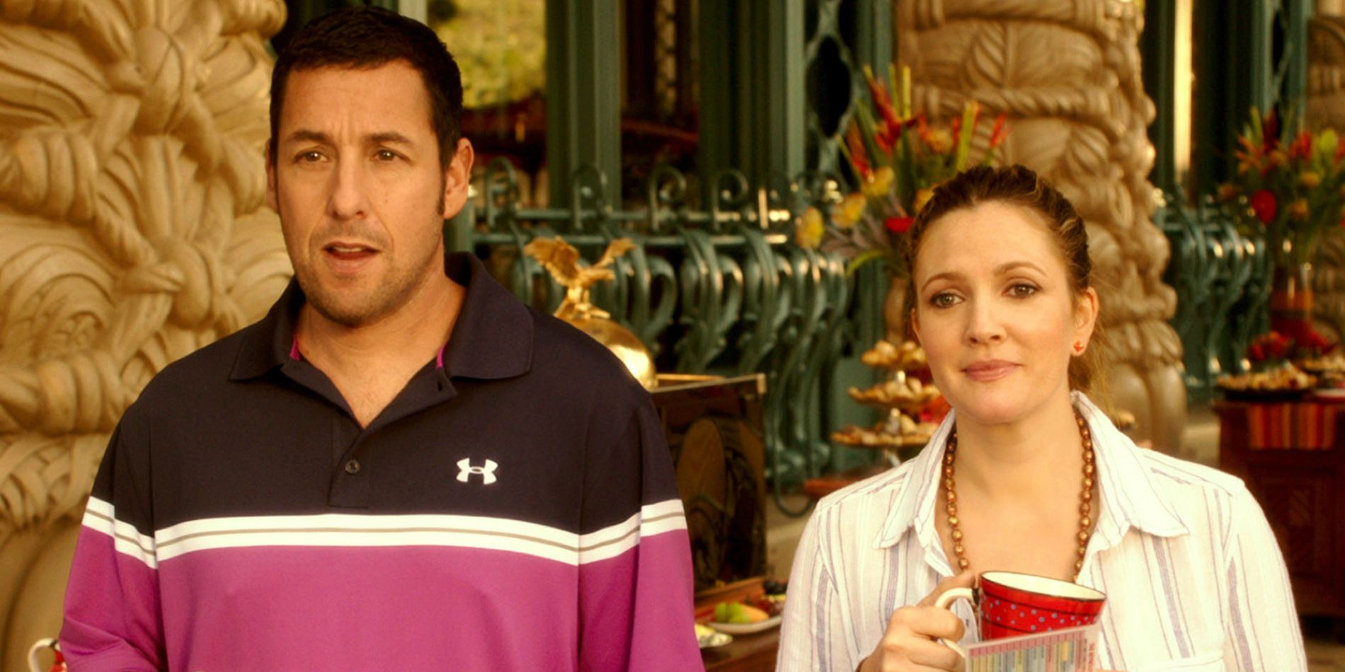 Adam Sandler and Drew Barrymore standing at a resort in Blended