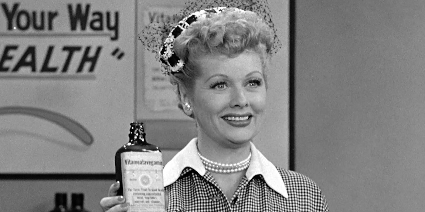 Lucille Ball smiling and holding a bottle in I Love Lucy