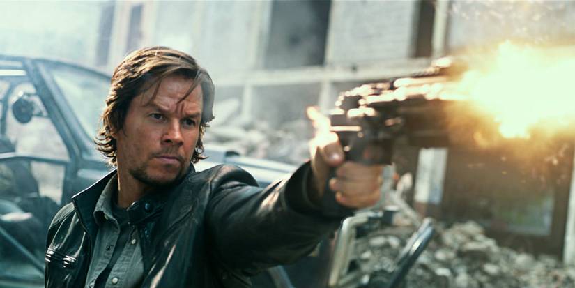 Mark Wahlberg as Cade shooting an alien gun in Transformers: The Last Knight