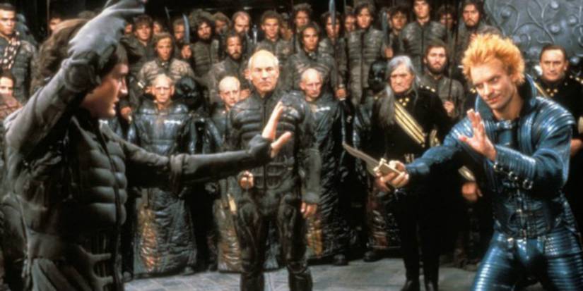 Paul Atreides fighting Feyd-Rautha while Gurney Halleck looks on.