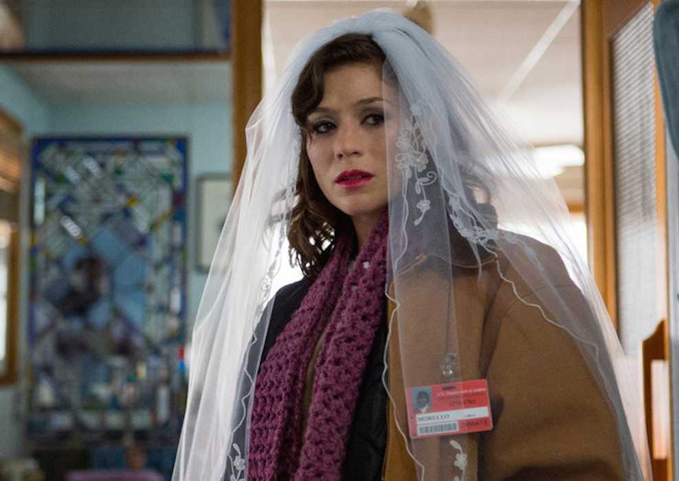 Lorna Morello (Yael Stone) wearing a wedding veil in Orange is the New Black