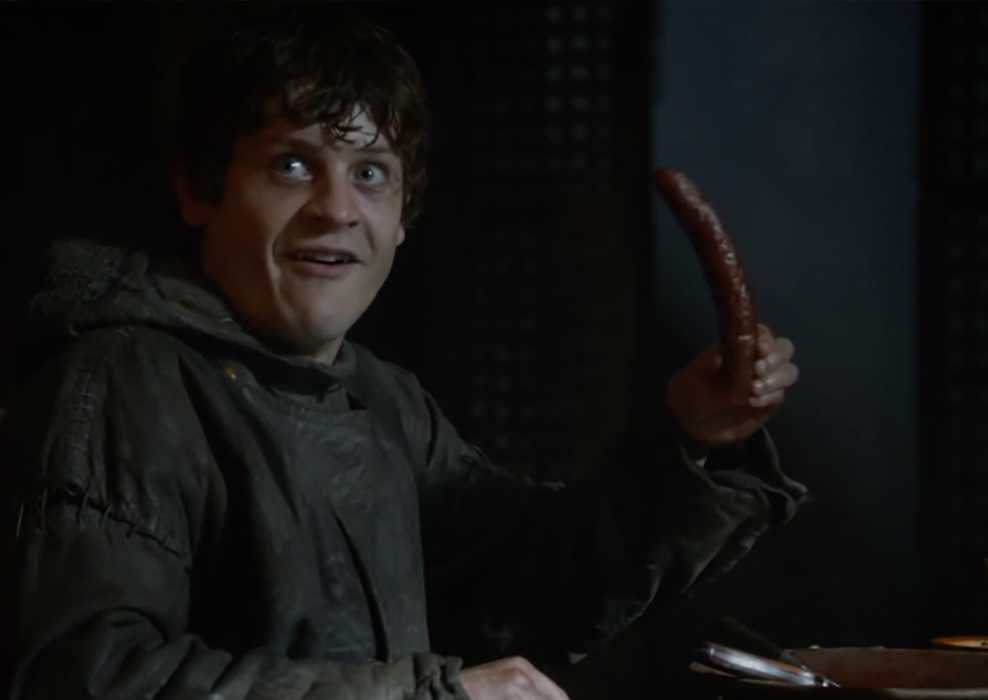 Ramsay Bolton holding a sausage in Game of Thrones