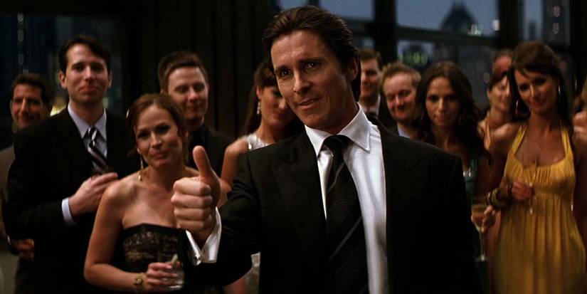 Christian Bale as Bruce Wayne giving the thumbs up at a fancy party in The Dark Knight