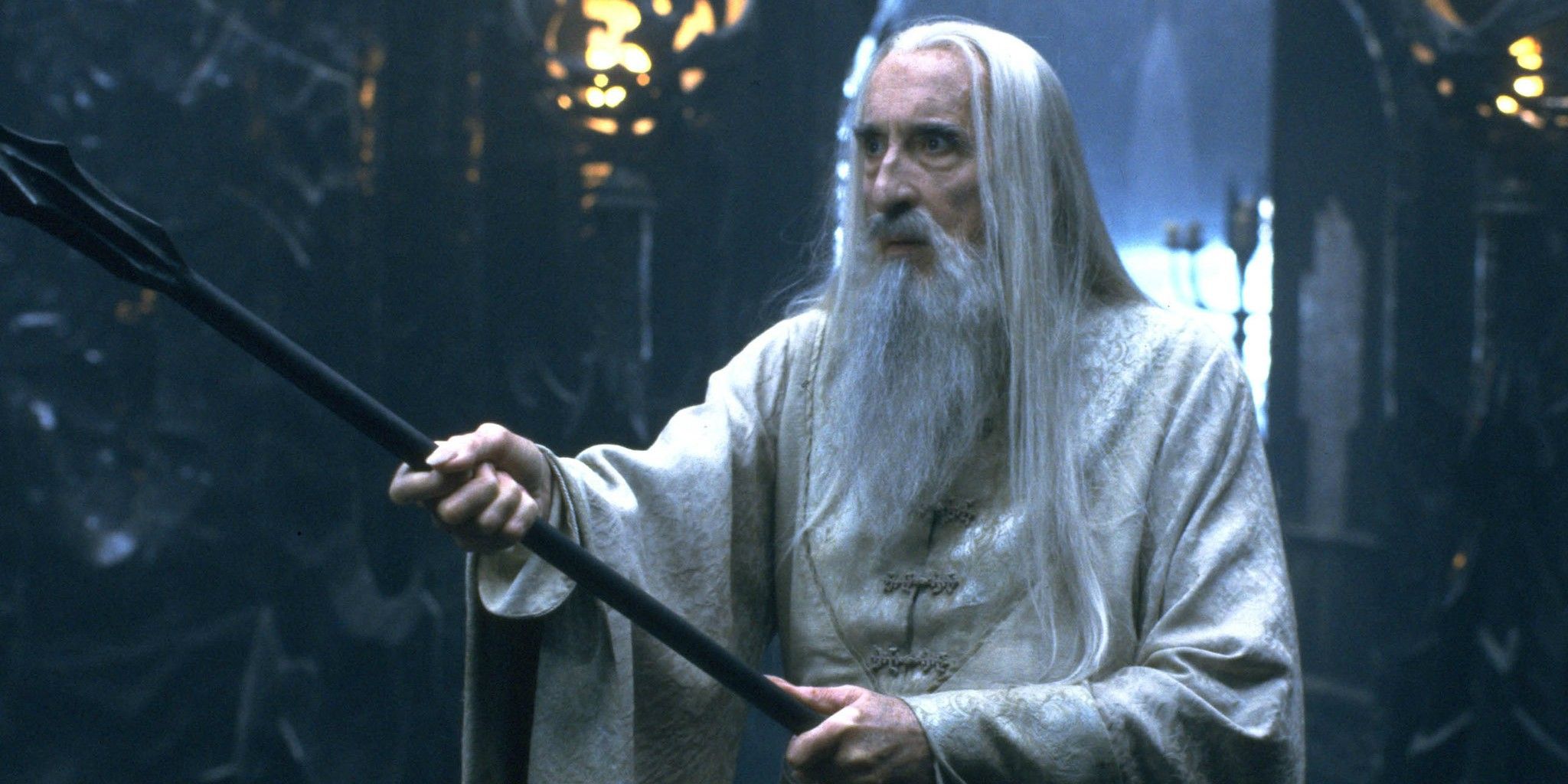 Christopher Lee as Saruman holding a staff in The Lord of the Rings