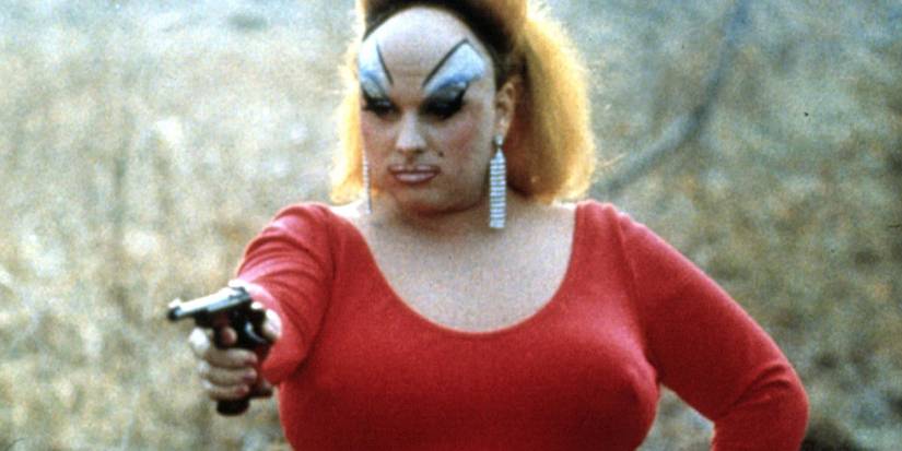 Divine points a gun in Pink Flamingos.