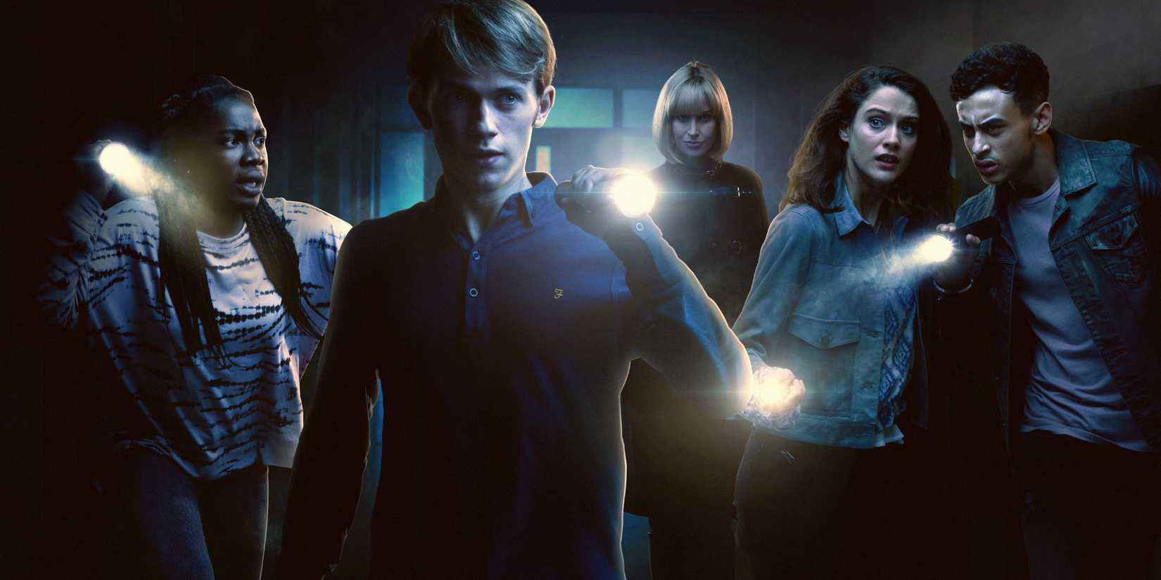 Charlie, Ram, April, Tanya, and Quinn in a dark hallway, carrying torches, in the Doctor Who spinoff Class.