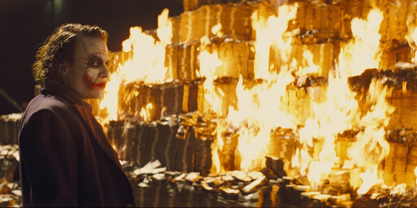 heath ledger as the joker in the dark knight burning money