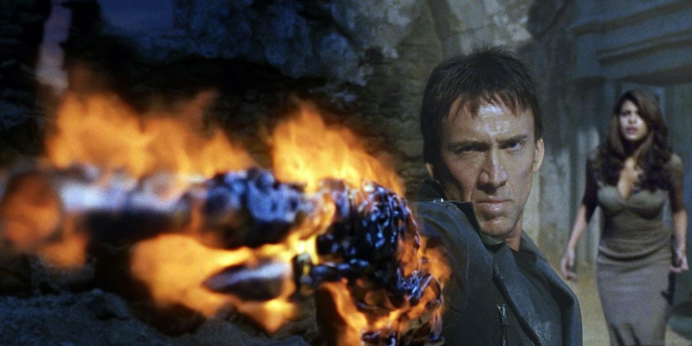 Nicolas Cage as Johnny Blaze holding a flaming chain and Eva Mendes in Ghost Rider