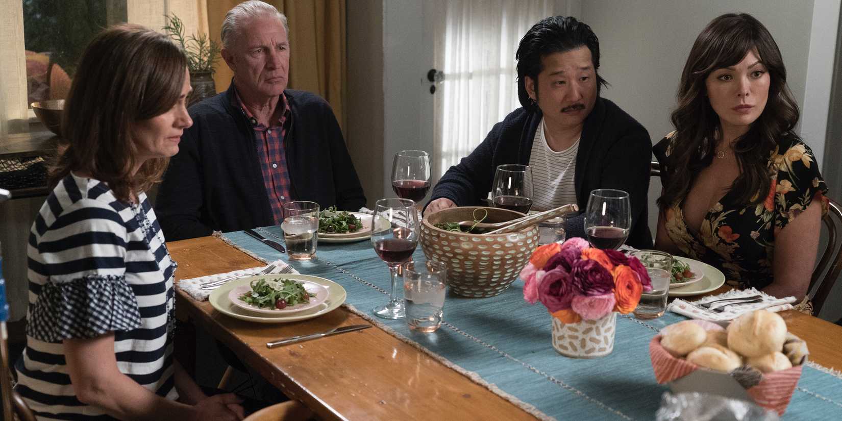 Diane Farr, Geoff Pierson, Bobby Lee, and Lindsay Price sitting at a dinner table in Splitting Up Together
