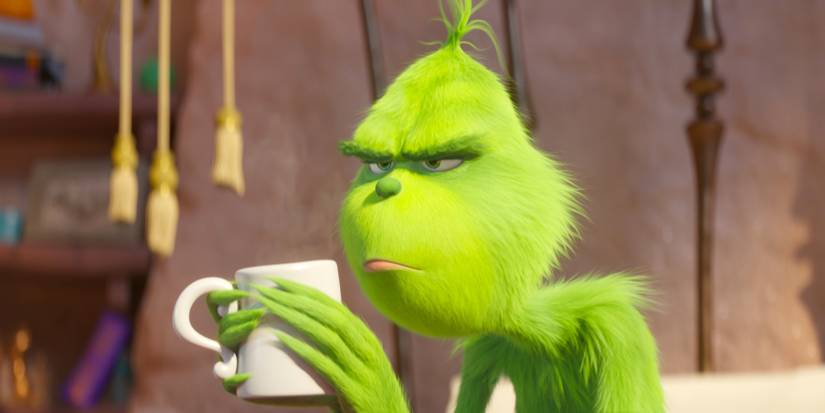 Il Grinch con un volto burbero e una tazza