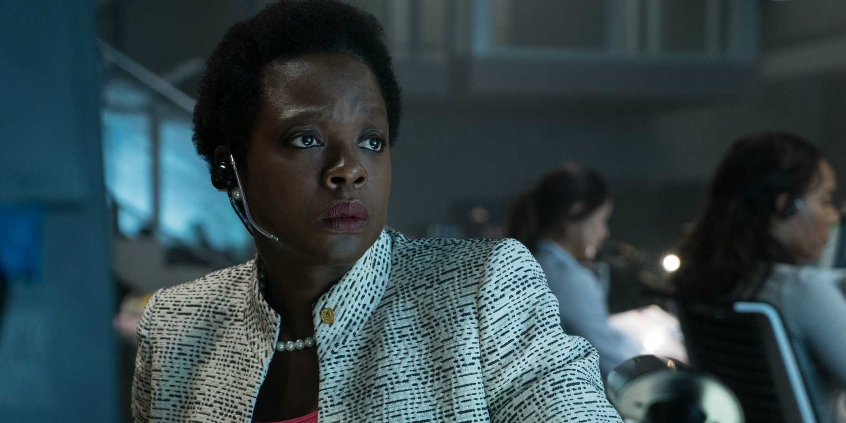 Viola Davis as Amanda Waller, looking concerned in a mission room in Suicide Squad