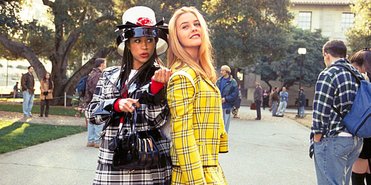 Dionne and Cher standing side by side at their school in Clueless.