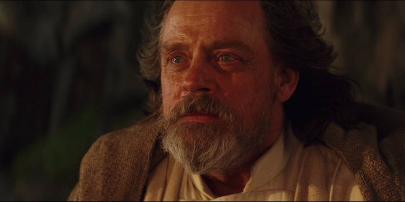 Luke Skywalker with a look of peace as he stares into the distance in Star Wars: The Last Jedi.