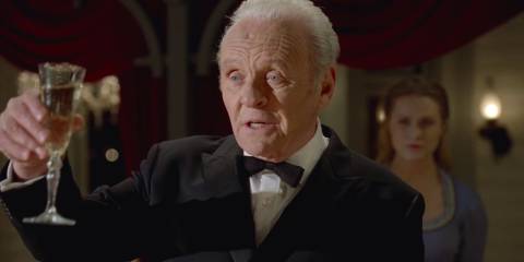 Robert Ford (Anthony Hopkins) raising his glass for a toast before Dolores Abernathy (Evan Rachel Wood) shoots him