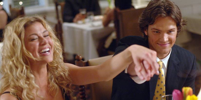 Supernatural's Sam Winchester and Jessica holding hands and showing off an engagement ring while smiling