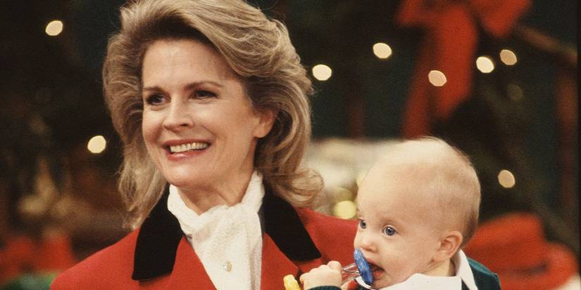 Candice Bergen como Murphy Brown segurando um bebê