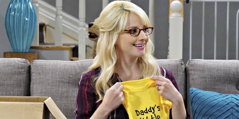 Melissa Rauch as Bernadette Rostenkowski Wolowitz holding baby clothes in The Big Bang Theory