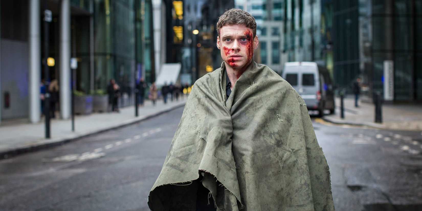 David Budd (Richard Madden) com sangue no rosto e um cobertor ao redor.