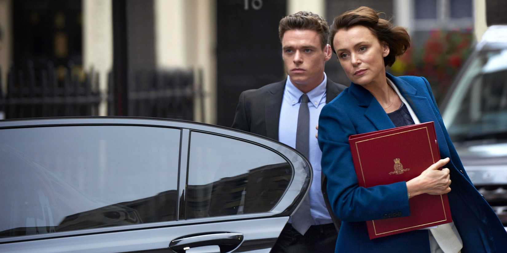 Richard Madden as David following Keeley Hawes as Julia out of a car in Bodyguard.