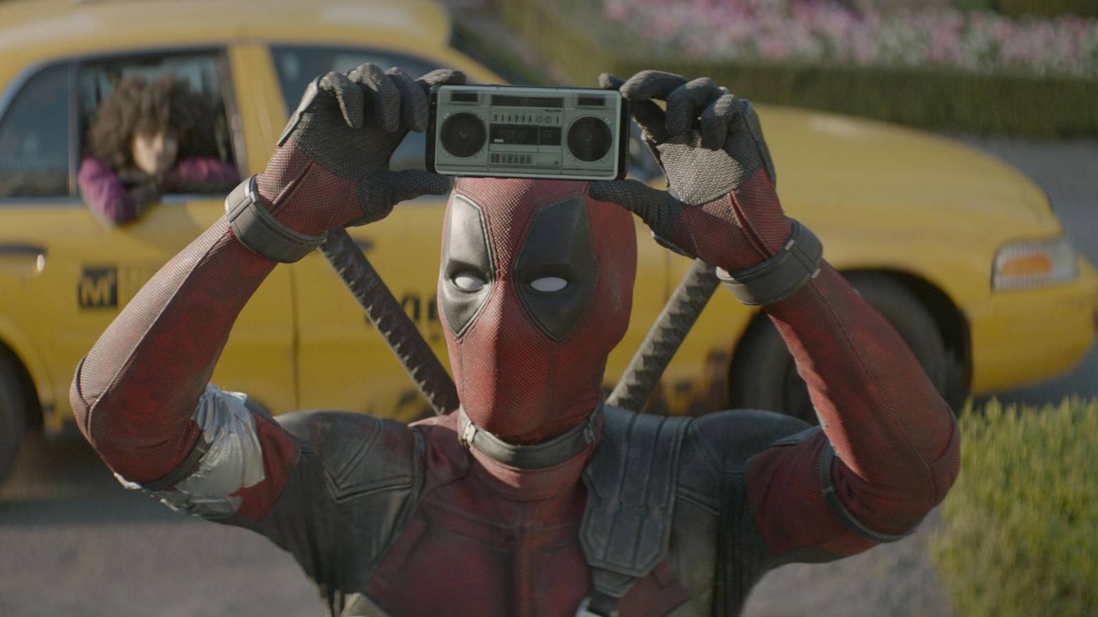 Deadpool holds up an iPhone with a stereo app in Deadpool 2