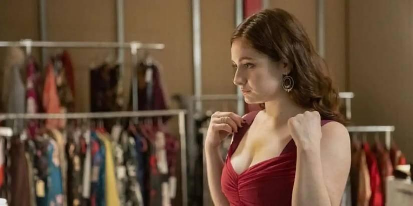 Debbie Gallagher (Emma Kenney) tries on red dress in luxury clothing scam 