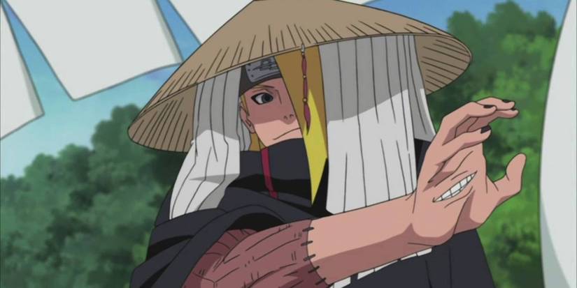 Deidara holding up his hand with an open mouth in Naruto