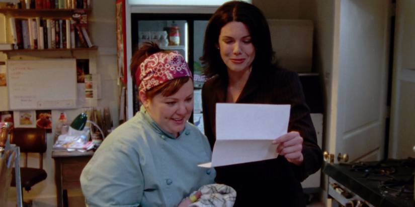 Sookie and Lorelai look at Rory's Chilton acceptance letter in Gilmore Girls' pilot episode.