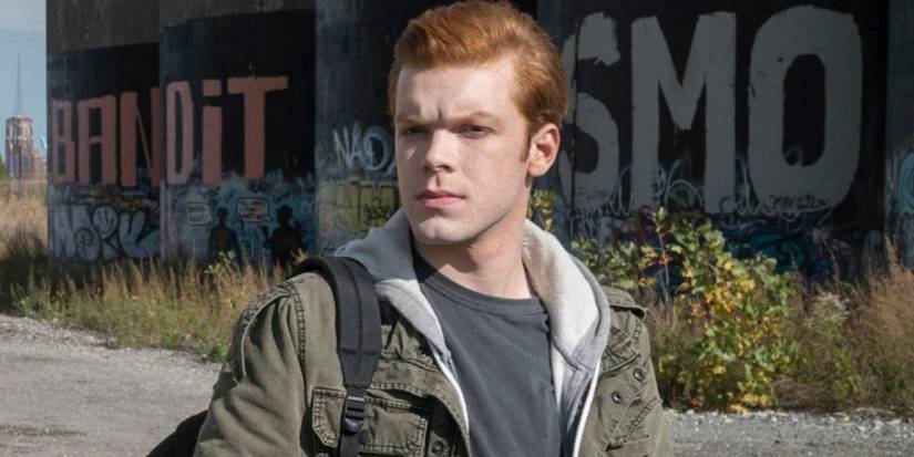 Ian Gallagher (Cameron Monaghan) with a backpack slung over his shoulder, frowning and looking for something in Shameless