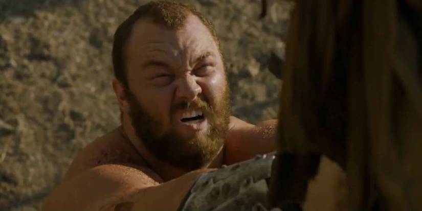 Gregor Clegane aka The Mountain lifting up a man with his sword in Game of Thrones