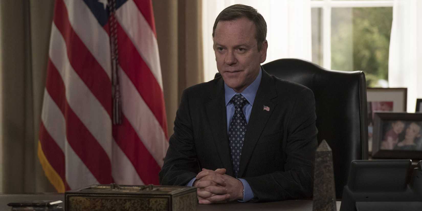 Tom Kirkman (Kiefer Sutherland) seated at an office, hands folded in an designated survivor.