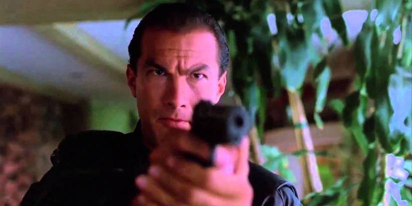 Steven Seagal as Mason pointing a gun at someone in Hard to Kill.