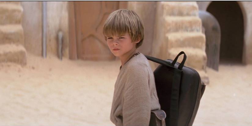 Anakin Skywalker looks toward the camera with a serious expression in The Phantom Menace.