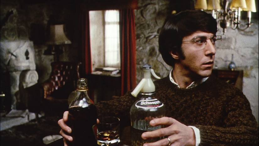 Dustin Hoffman picks two glass bottles up in Straw Dogs