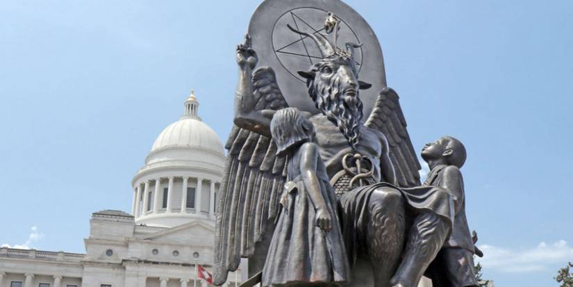  still from Hail Satan featuring a statue of Satan seated on a throne