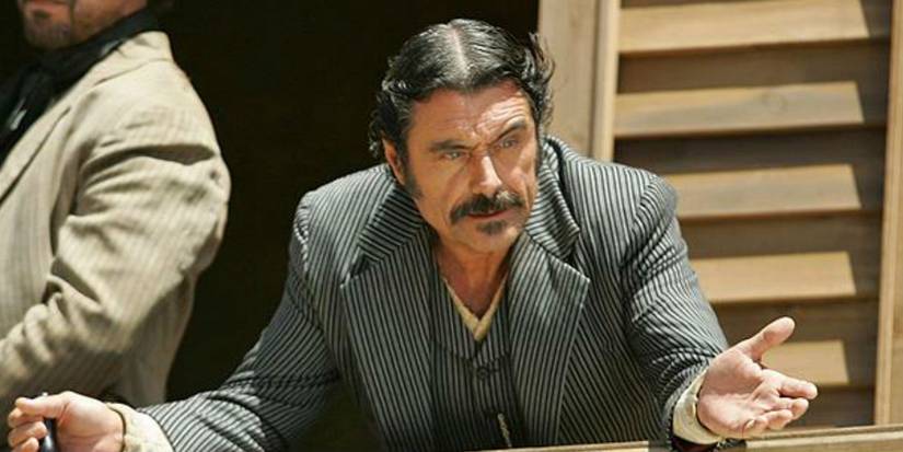 Ian McShane as Al Swearengen looking down from his balcony in Deadwood