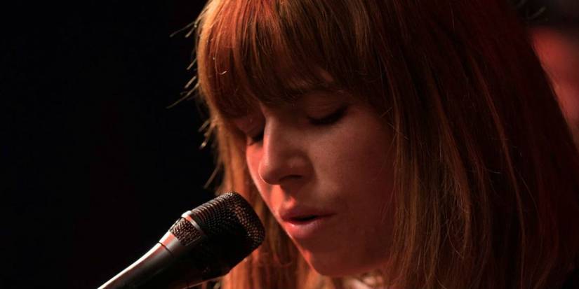 If You're Looking For More Of Jessie Buckley, Check Out Her Performance In This Must-Watch 2018 Movie 3 Jessie Buckley singing into a microphone in Wild Rose