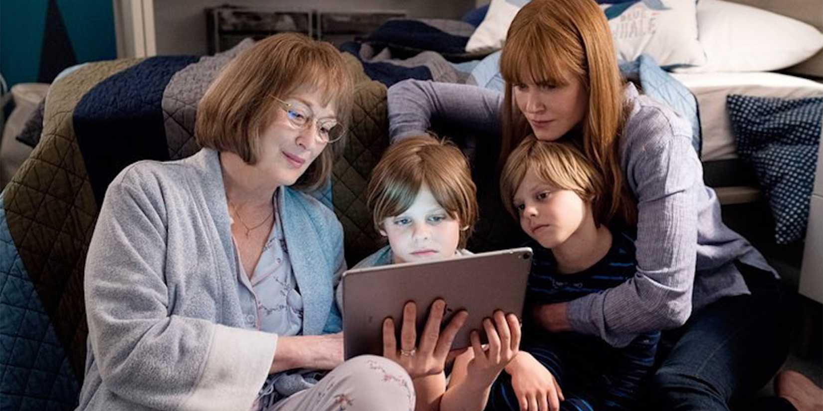 Meryl Strep and Nicole Kidman watch something with two children on an Ipad in Big Little Lies Season 2 HBO